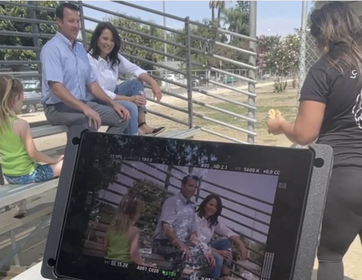 Marie Finch filming a warm family scene outdoors